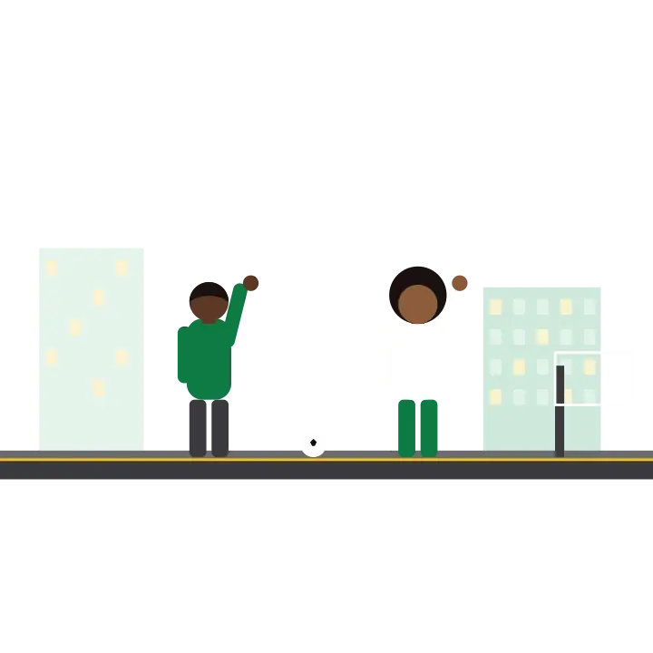 Two friends playing football on a street with a ball in mid-air